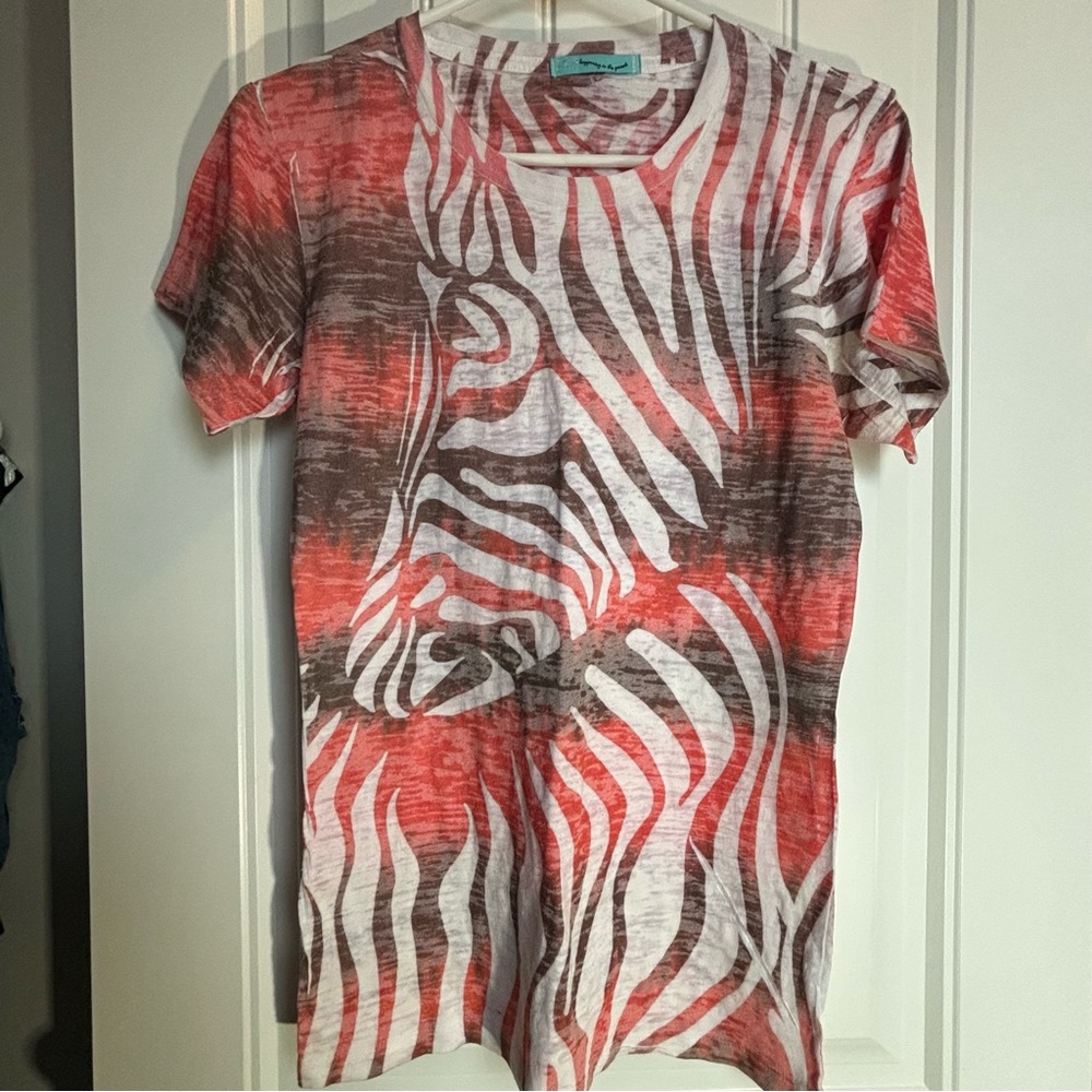 Sheer T shirt that has peach, white, and brown colors